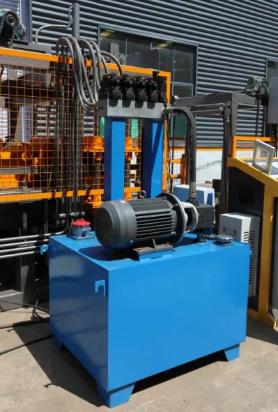 Blue hydraulic station with oil tank, pump motor and valve block.