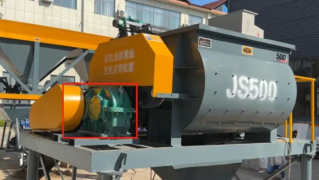 JS500 mixer drum with its orange guard and the green reducer drive marked with a red box.